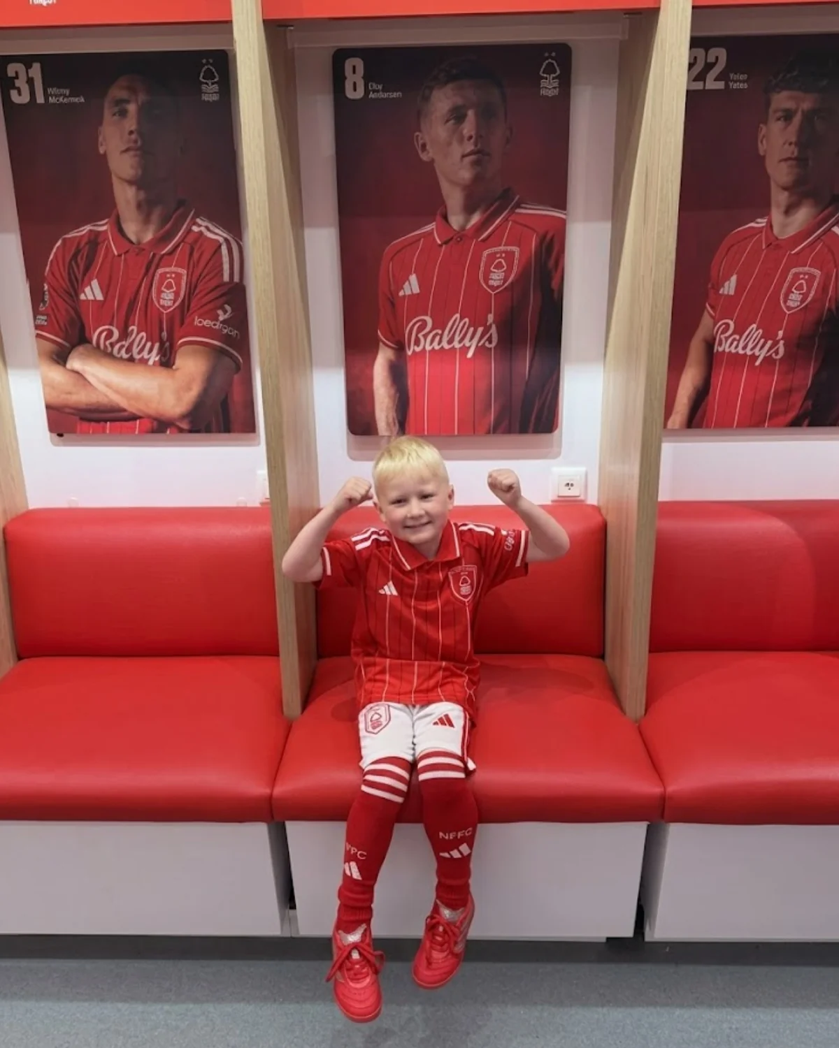 Young football fan wearing their football kit